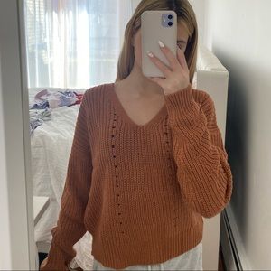 brownish orangish sweater with crossed back